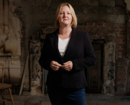 a female presenter in an abandoned house