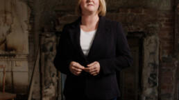 a female presenter in an abandoned house