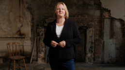 female presenter in abandoned building