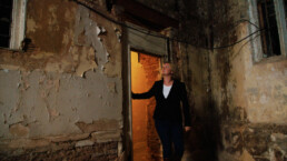 woman walks through abandoned building