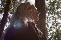 a low angle shot of a woman in a forest