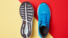 Blue running sneakers on red and yellow background. Pair of sport male shoes for fitness, top view