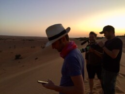 Chris Jones checks his phone in the desert